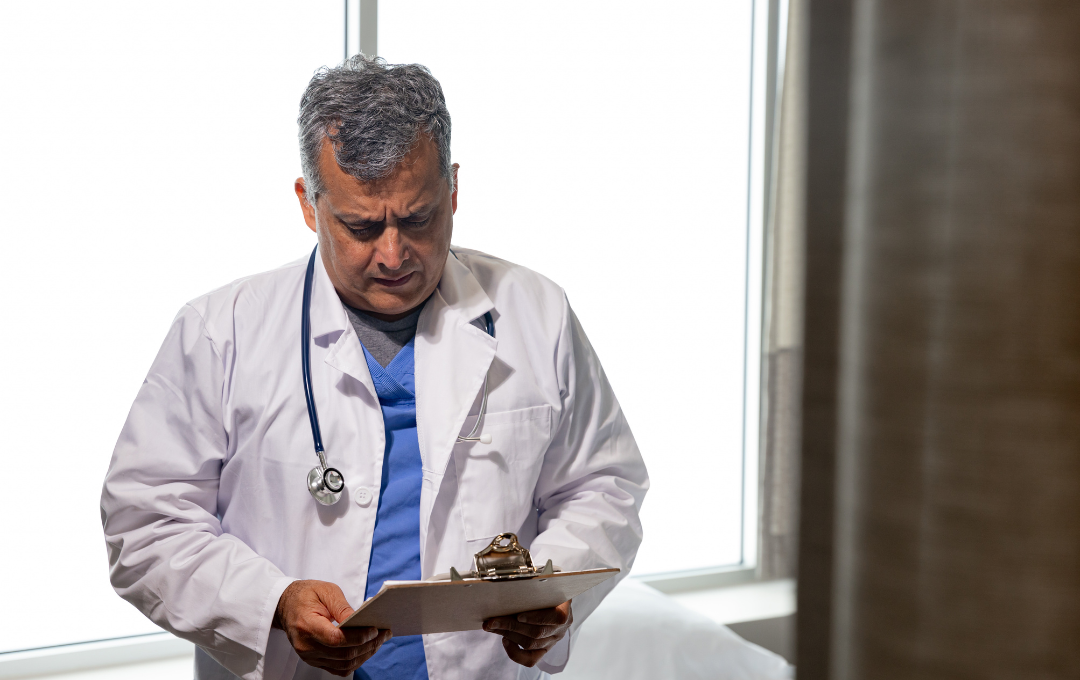 Hemorrhoid specialist reviewing patient's symptom details.