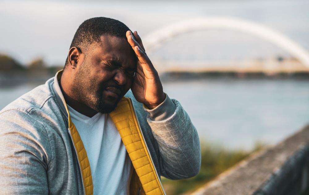 Person with hemorrhoids dealing with a headache