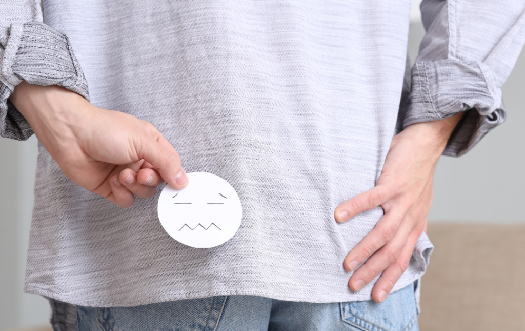 Person experiencing discomfort due to a prolapsed hemorrhoid